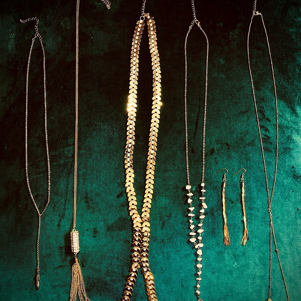Golden pendants with crystal or stone. Golden earrings. Very shiny.